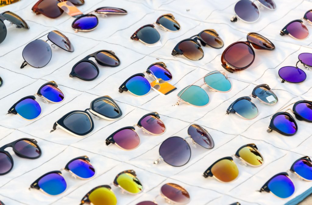 A close-up image of a collection of many different types of protective sunglasses.