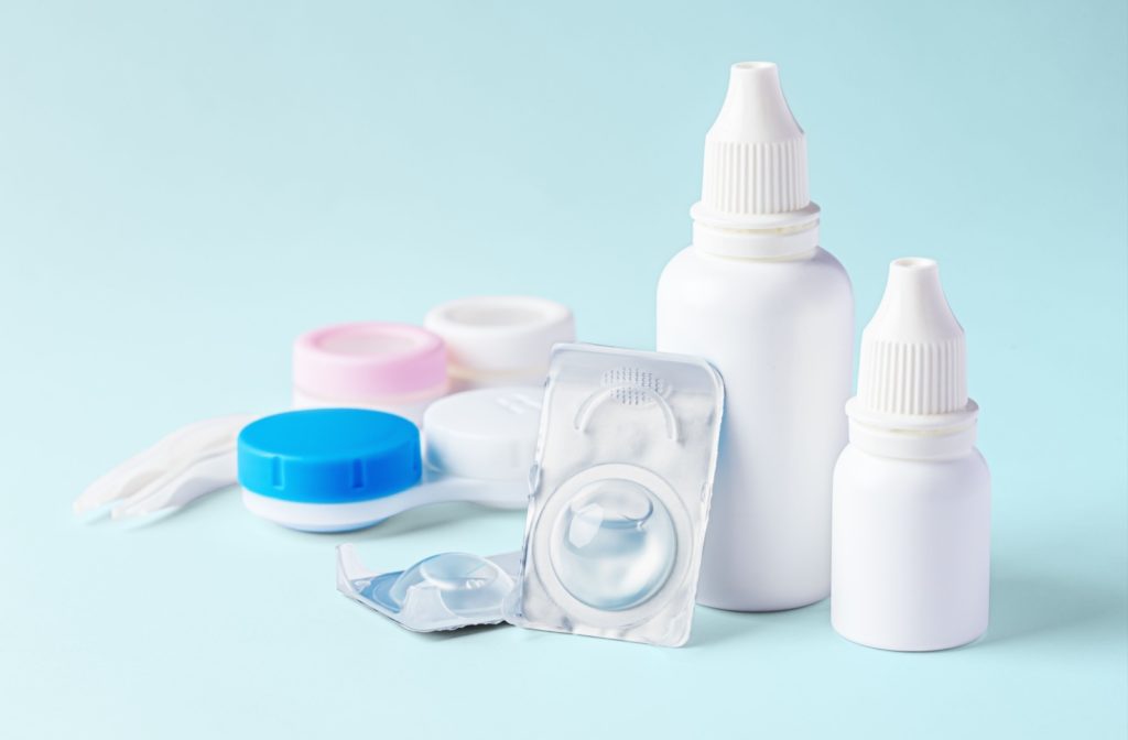 Contact lenses, contact lens case, and contact lens cleaning solution against a light blue background.