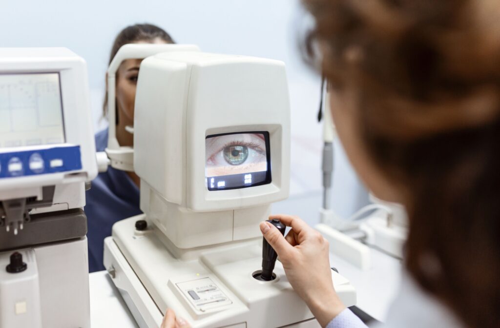 An optometrist performing an eye test on a patient during an eye exam.